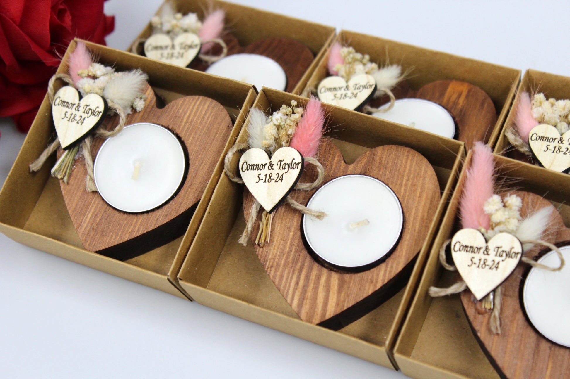 Personalized Heart-Shaped Wooden Candle Holders with Dried Flowers, custom engraved with example names 'Connor & Taylor' and date '5-18-24'. Handcrafted rustic wedding favors featuring delicate dried flower arrangements, perfect for adding a personal touch to your special day