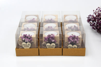 Set of personalized wooden candle holder wedding favors with purple dried flowers and custom engraving 'Jenna & Alex 5/4/2024', displayed in clear gift boxes, perfect for special occasions.