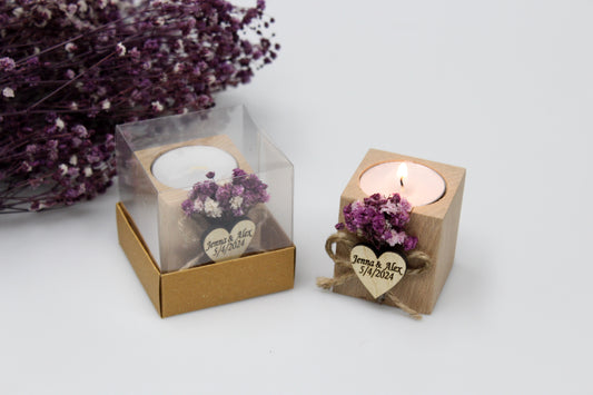 Personalized wooden candle holder wedding favors with purple dried flowers and custom engraving 'Jenna & Alex 5/4/2024', displayed in a clear gift box and lit candle, perfect for special occasions.