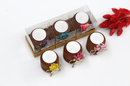 Rustic wooden tea light candle holders with dried flower embellishments in various colors. The candle holders are personalized with a heart-shaped tag and are displayed both in individual clear boxes and out of packaging. Perfect as unique wedding favors. Names and dates on tags are for example purposes only