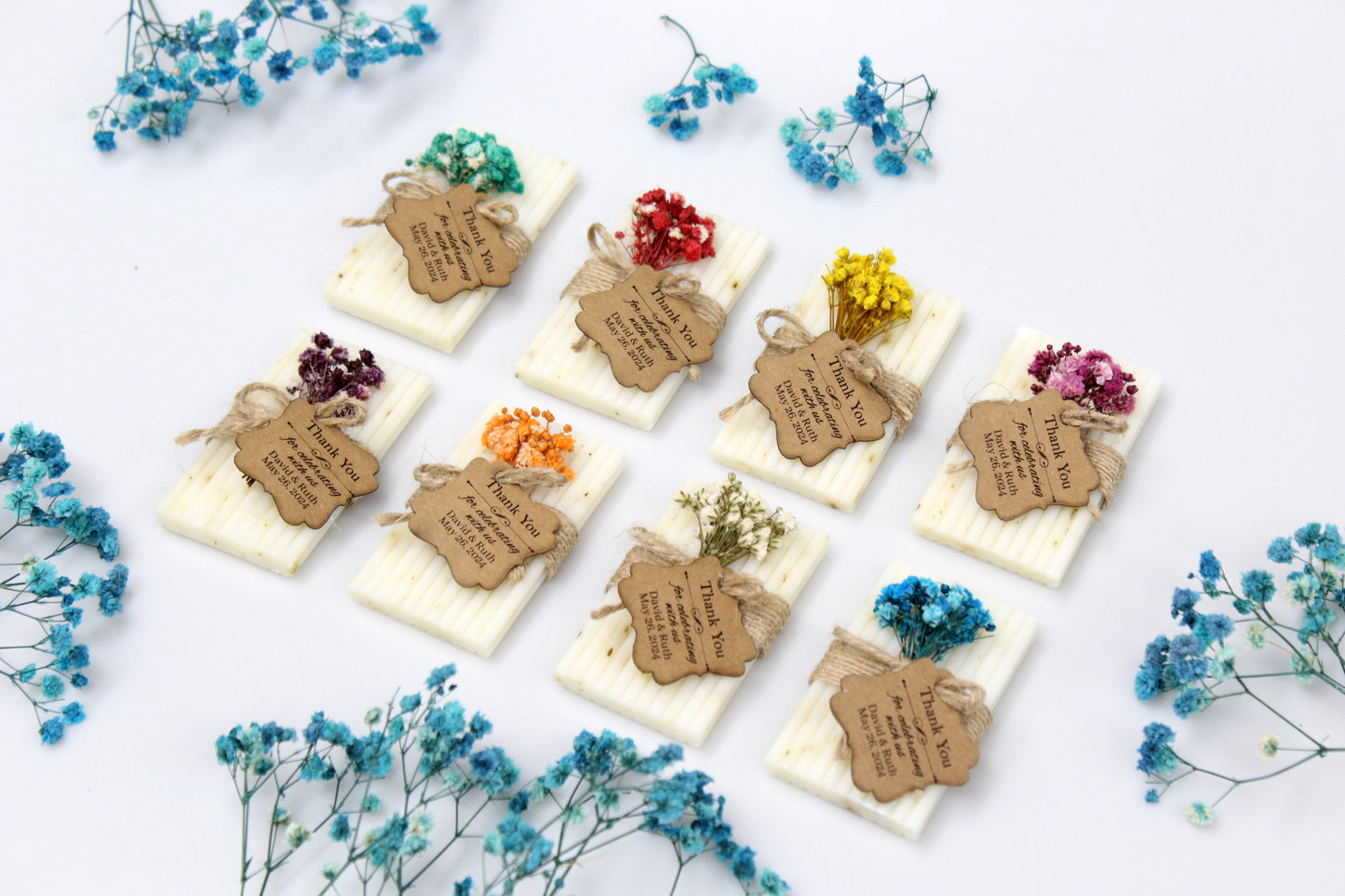 Elegant personalized handmade wedding soap favors adorned with various dried flower arrangements. Each soap bar is wrapped in rustic twine and features a customizable thank you tag, perfect for adding a personal touch to wedding celebrations. Ideal for rustic and handcrafted wedding themes