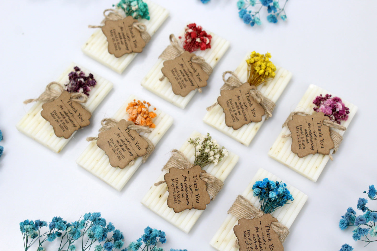 Beautifully personalized handmade wedding soap favors featuring colorful dried flower arrangements. Each soap bar is wrapped in rustic twine with a custom thank you tag, perfect for adding a personal and elegant touch to wedding celebrations. Ideal for rustic and handcrafted wedding themes