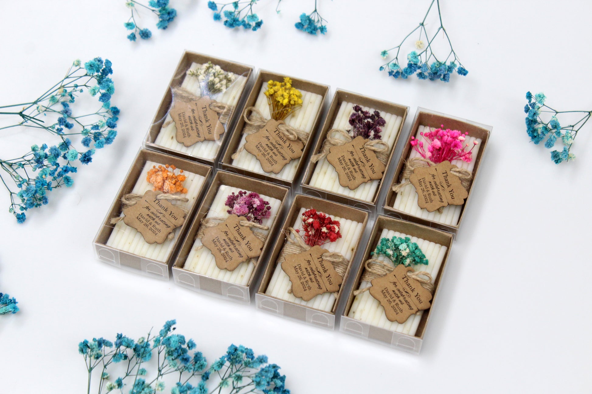 Assorted personalized handmade wedding soap favors featuring dried flower arrangements. Each soap bar is wrapped with rustic twine and includes a customizable thank you tag, perfect for adding a personalized touch to wedding celebrations. Ideal for rustic and handcrafted wedding themes.