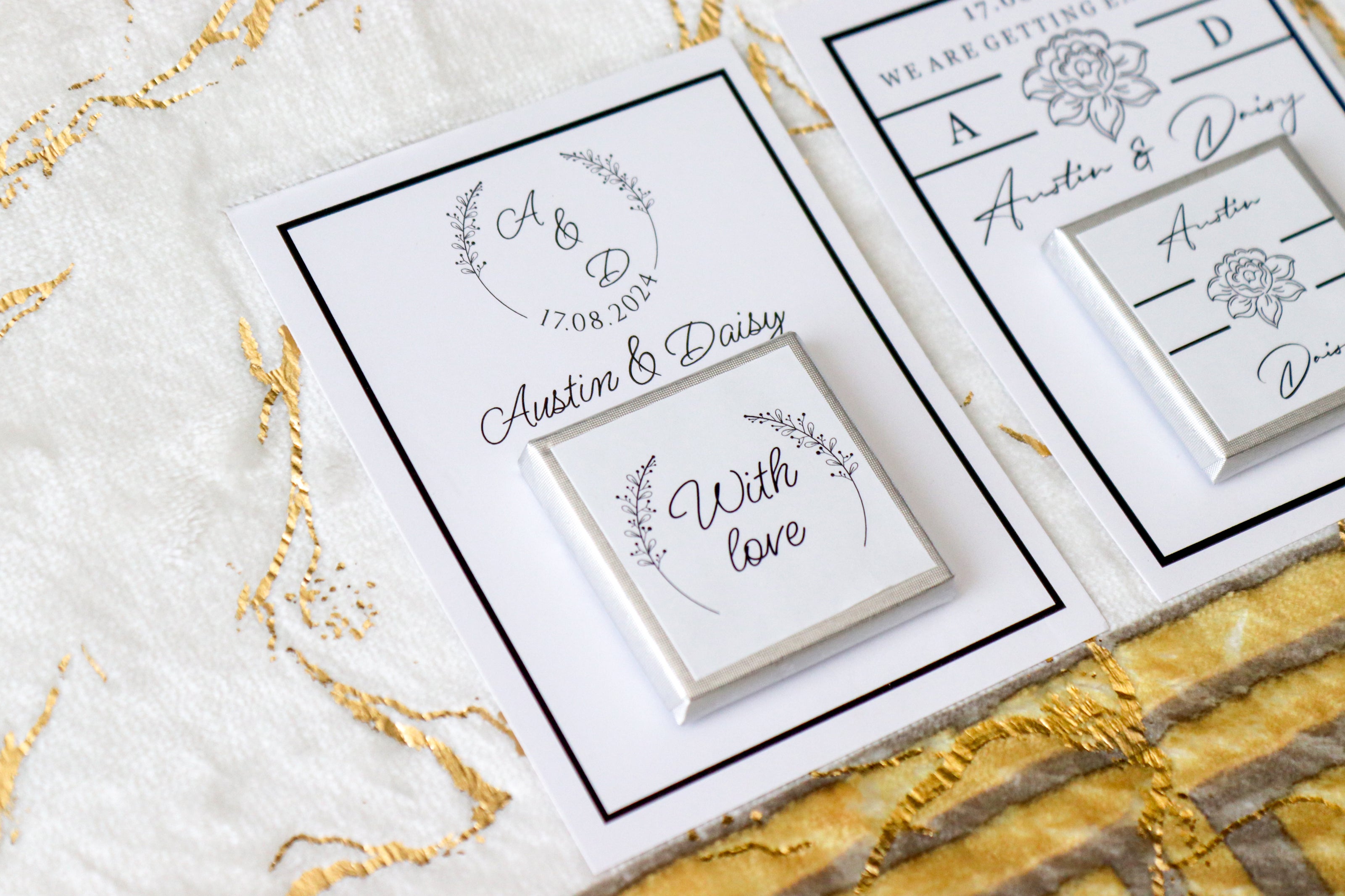 Close-up of a personalized engagement favor card for Austin and Daisy, featuring custom names, date 17.08.2024, floral designs, and the message 'With love,' displayed on a luxurious white and gold textured background.