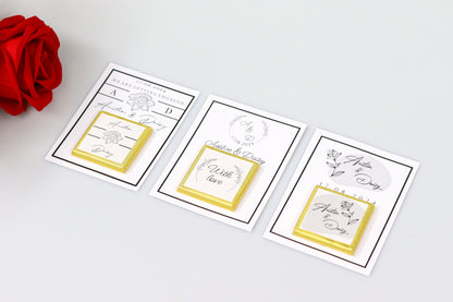 Three personalized engagement favor cards featuring custom names Austin and Daisy, with elegant floral designs, gold ribbon borders, and the message 'With love,' displayed alongside a red rose on a white background.